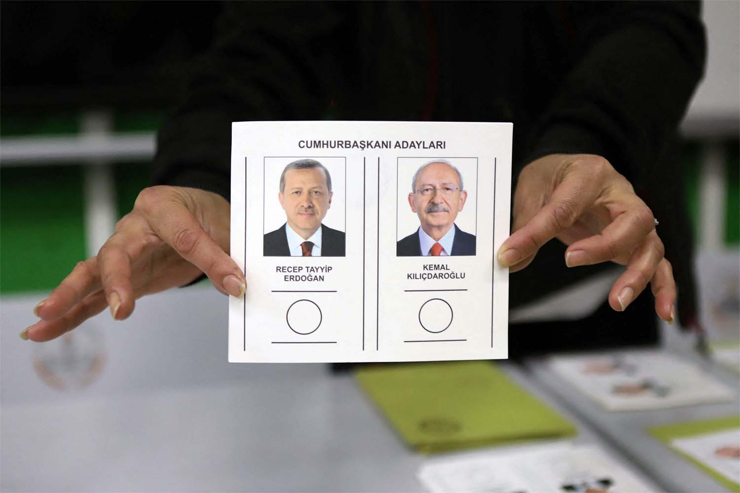 An election official displays a ballot