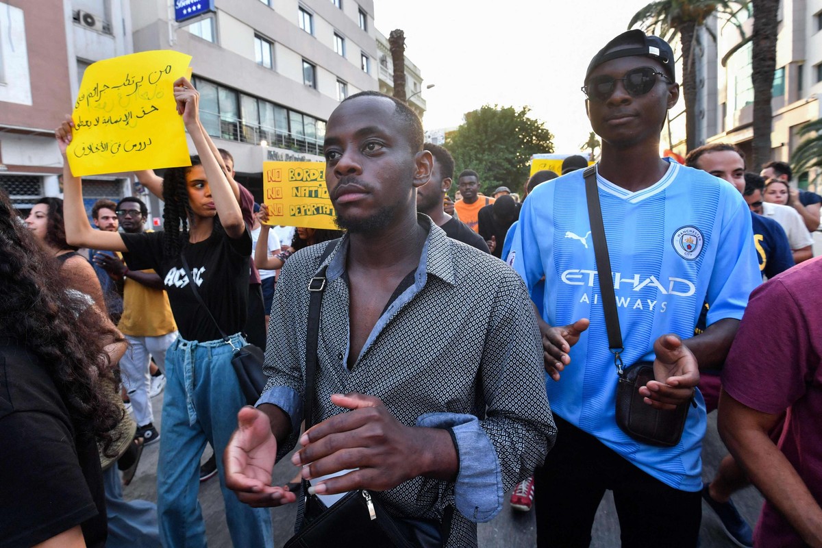 متظاهرون يرفعون شعارات تعبر عن تضامنهم مع المهاجرين الأفارقة