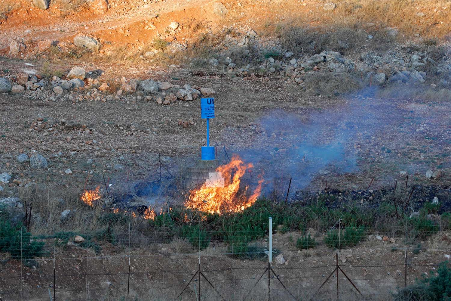 Smoke billows from a fire caused by the Lebanese in the blue line area