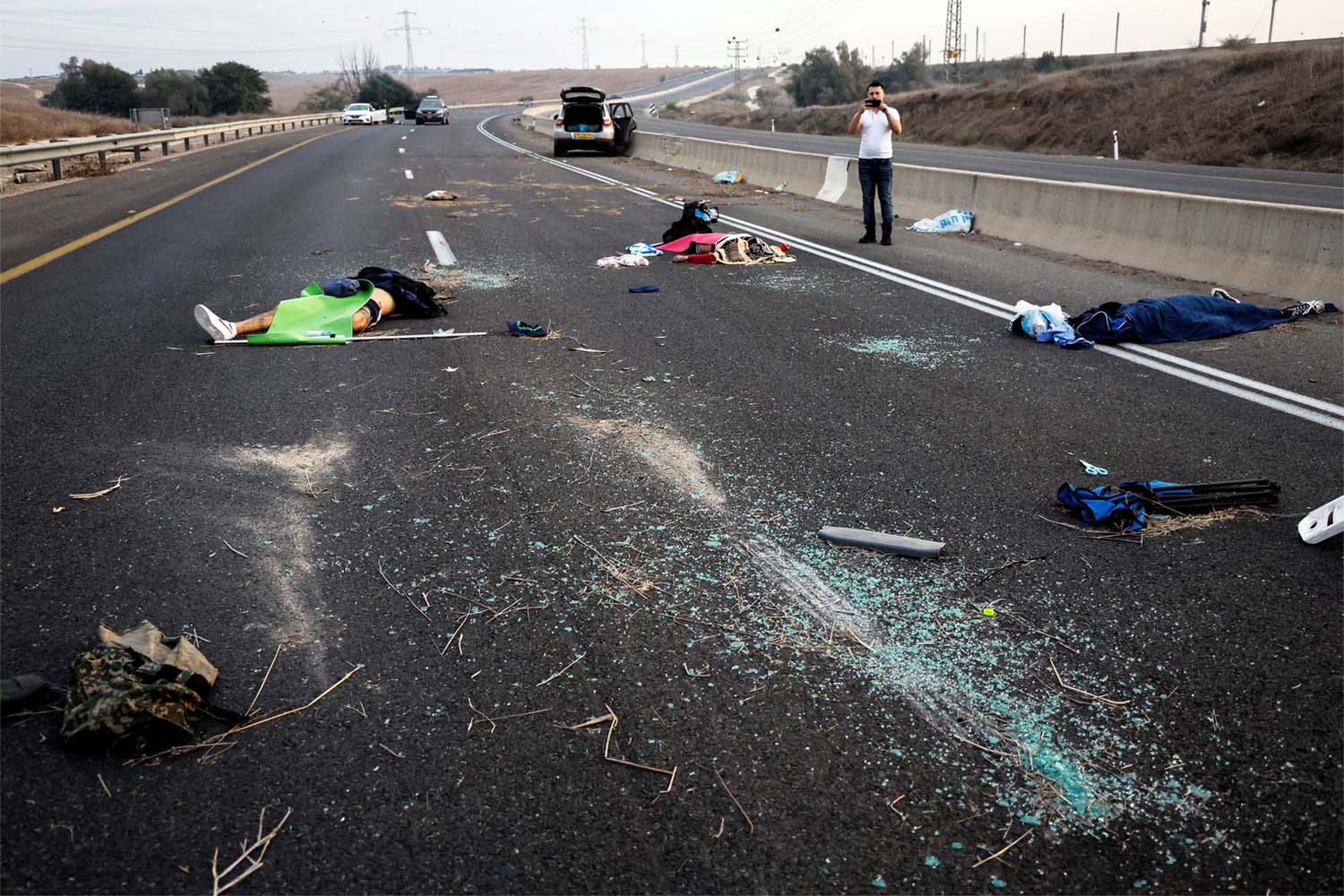 Dead people strewn across a road following a mass-infiltration by Hamas gunmen in the Sderot area