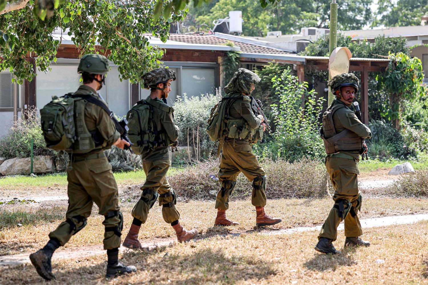 Israeli soldiers patrol in kibbutz Kfar Aza in southern Israel near the Gaza Strip