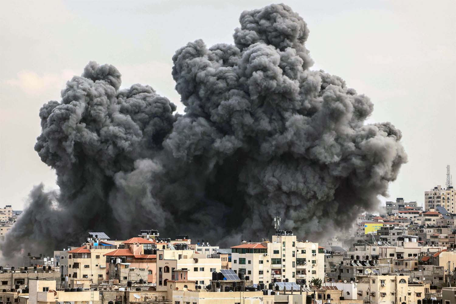 A plume of smoke rises in the sky of Gaza City during an Israeli airstrike
