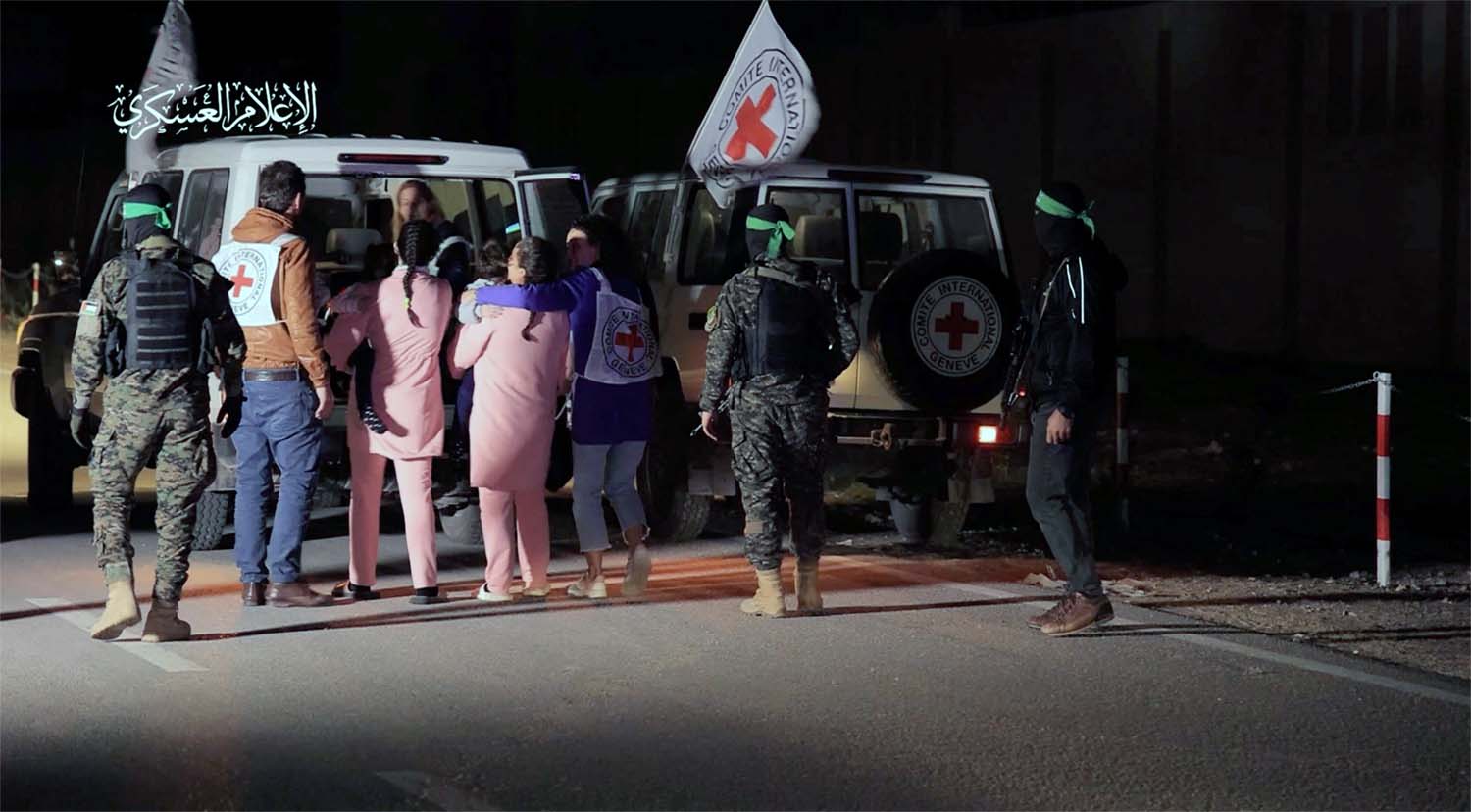 Hostages who were abducted by Hamas gunmen during the October 7 attack on Israel,are handed over by Hamas militants to ICRC members
