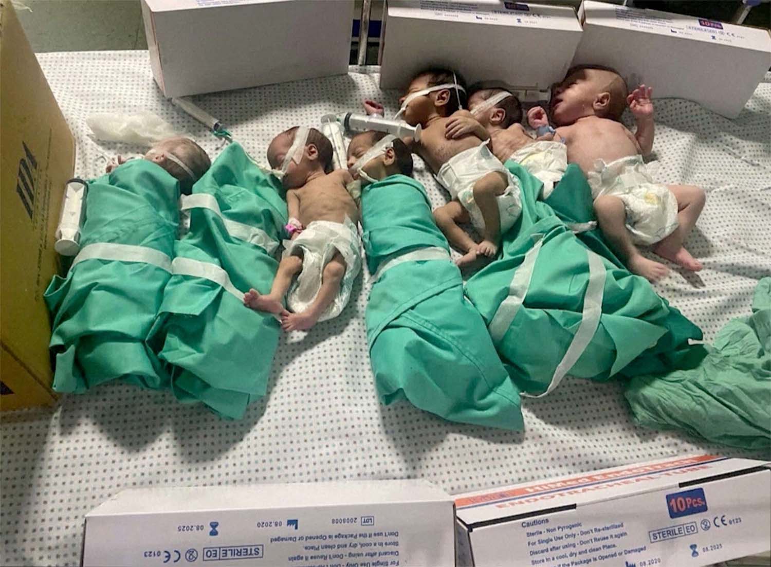 Newborns are placed in bed after being taken off incubators in Gazas Al Shifa hospital after power outage