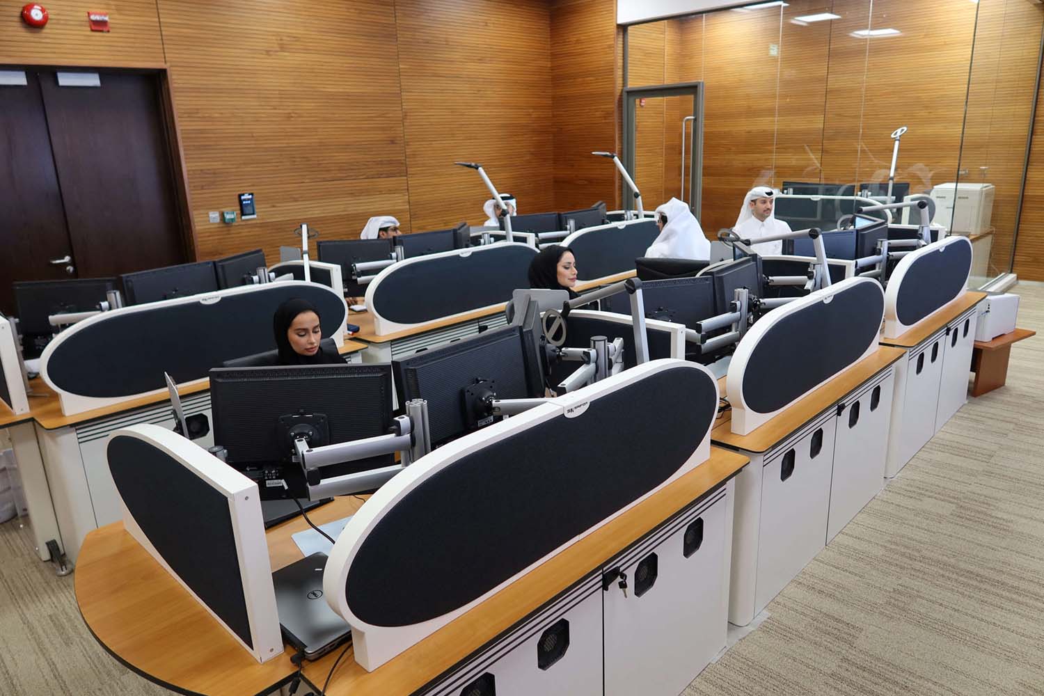 Qatari diplomats work inside an operation room set up to coordinate the truce and release of hostages between Israel and Hamas