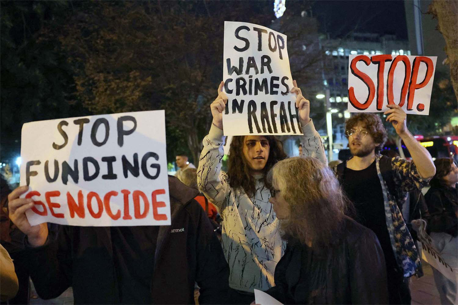Demonstrators gather with signs during a protest by Israeli left-wing activists against the war in the Gaza Strip 