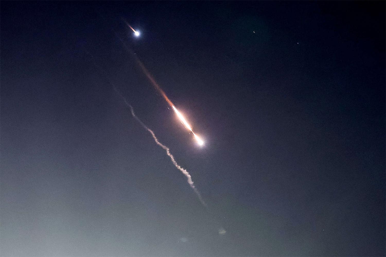 Objects are seen in the sky above Jerusalem after Iran launched drones and missiles towards Israel