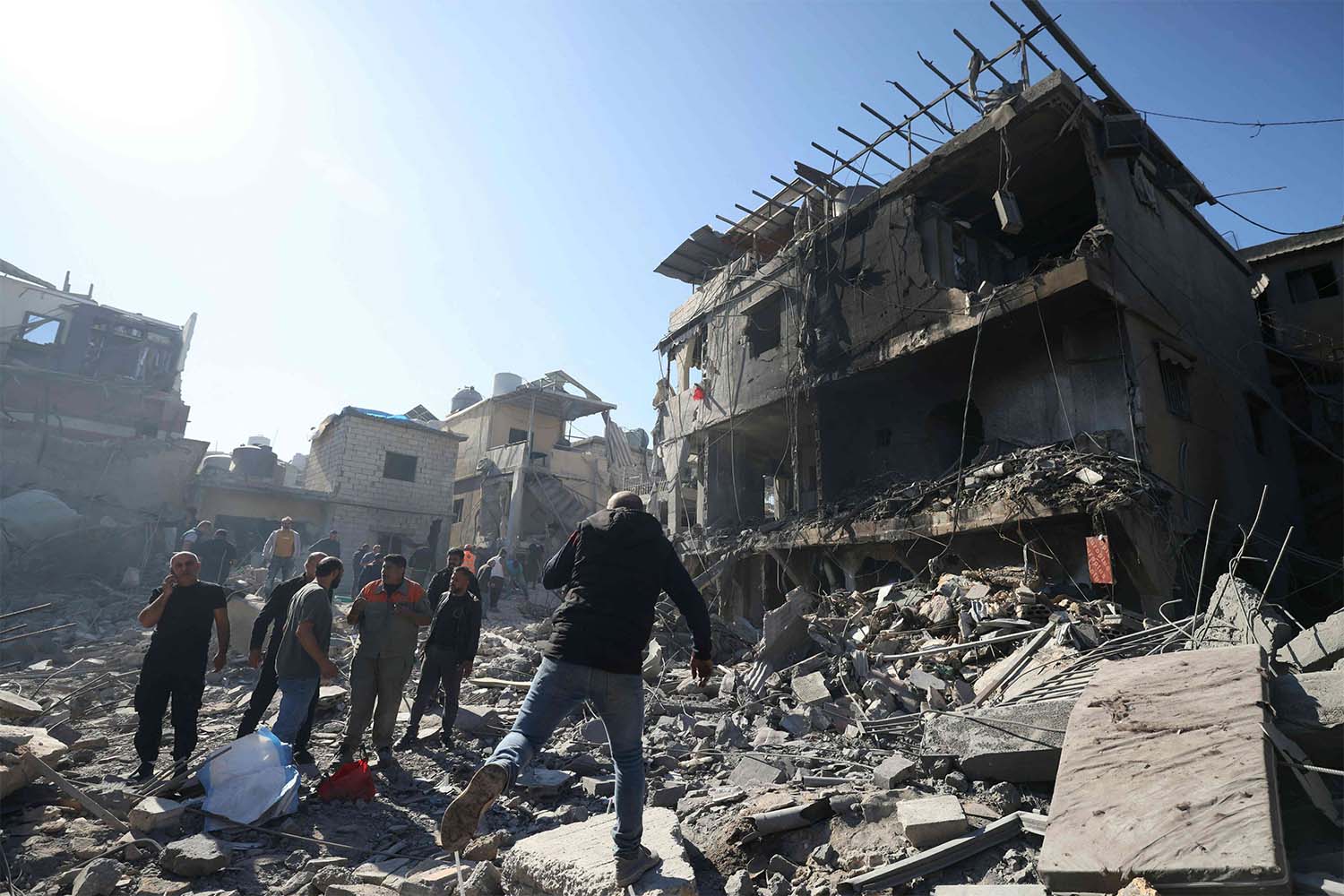 People inspect the debris a day after an Israeli airstrike in Beirut''s southern suburb of Jnah
