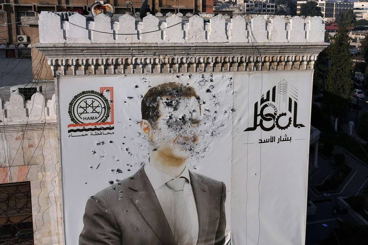 جدارية مشوهة للرئيس بشار الأسد وسط حماة