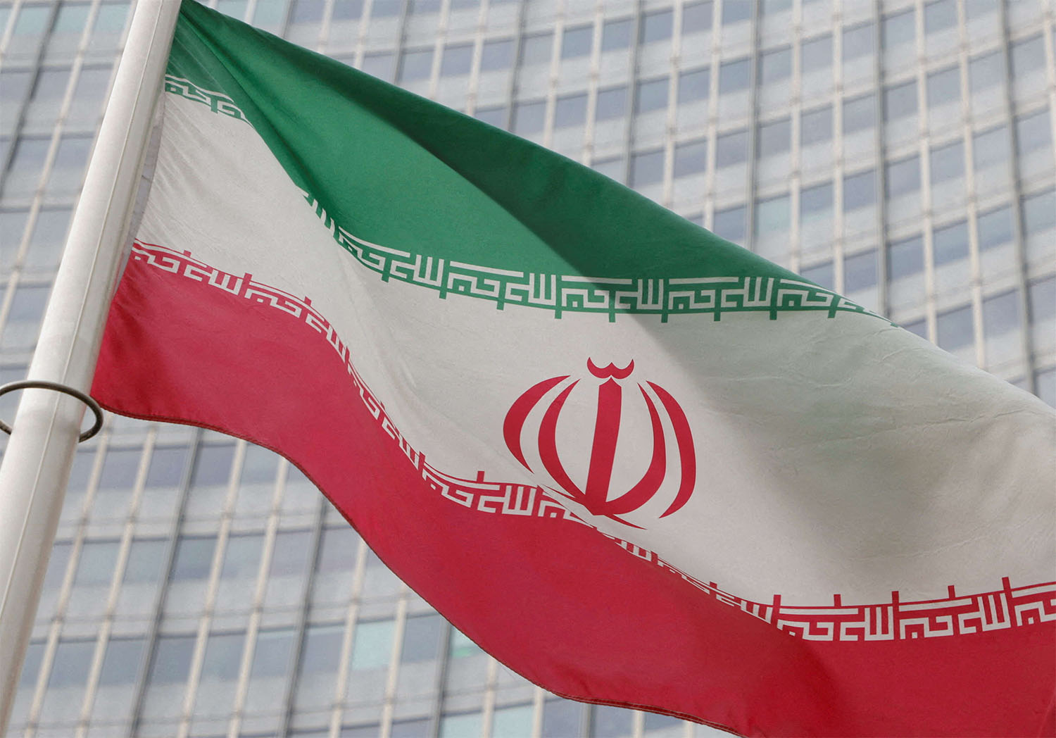 The Iranian flag flutters outside the IAEA headquarters in Vienna