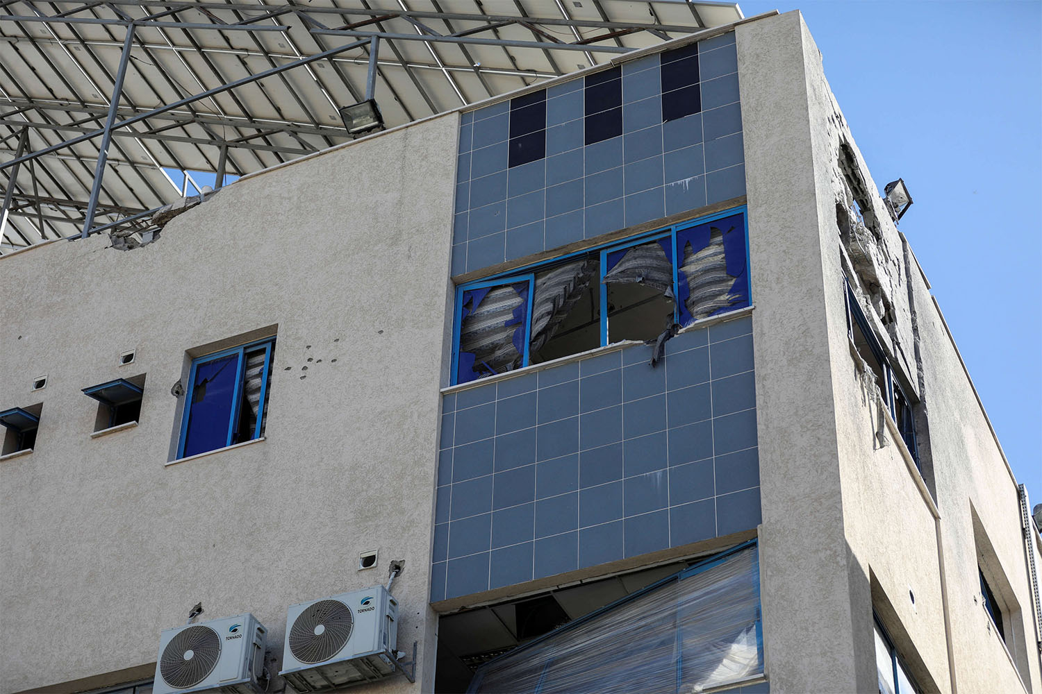 Al-Ahli Arab Baptist hospital stands damaged following an Israeli strike