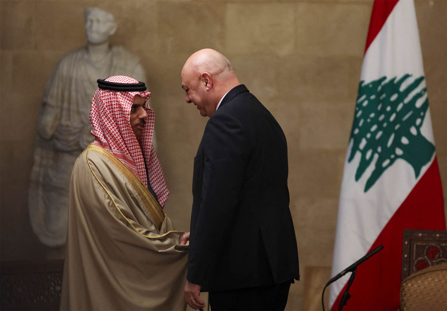 Saudi FM Prince Faisal bin Farhan Al Saud shakes hands with Lebanese President Joseph Aoun at the presidential palace, in Baabda