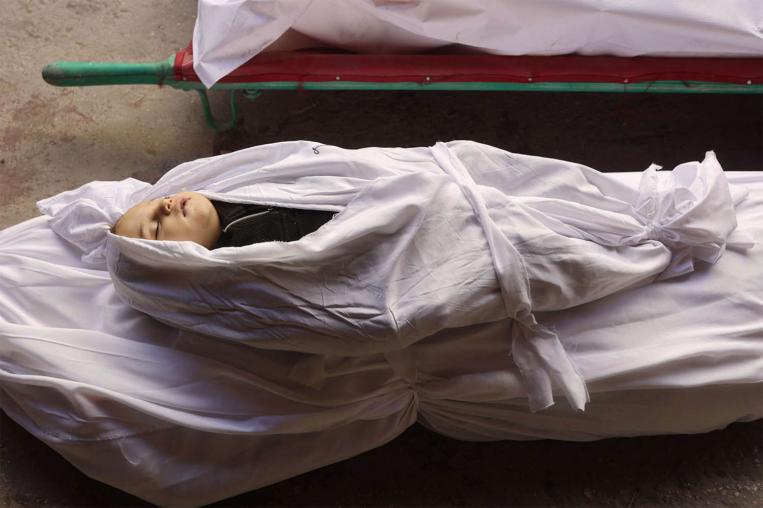 The shrouded body of a child killed in an overnight Israeli airstrike on the Gaza Strip 