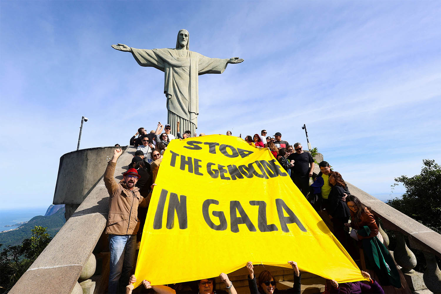 Activists hold a banner that reads Stop the genocide in Gaza during a protest to demand an immediate ceasefire in the region and the urgent entry of humanitarian aid for the Palestinians, at the Christ the Redeemer statue in Rio de Janeiro, Brazil June 14