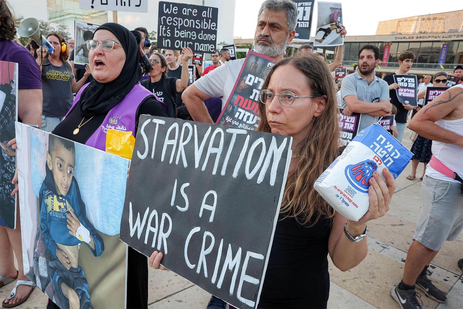 Israeli activists denouncing the ongoing food shortage and forced displacement of Palestinians in the Gaza Strip