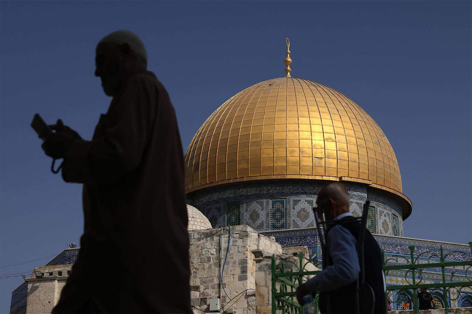Muslim worshippers walk next to the Dome of the Rock mosque at the Al-Aqsa mosque compound in Jerusalems Old City 