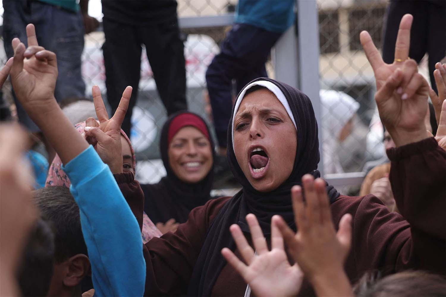 Palestinians celebrate in Deir al-Balah in the Gaza Strip following news of a new Gaza ceasefire deal