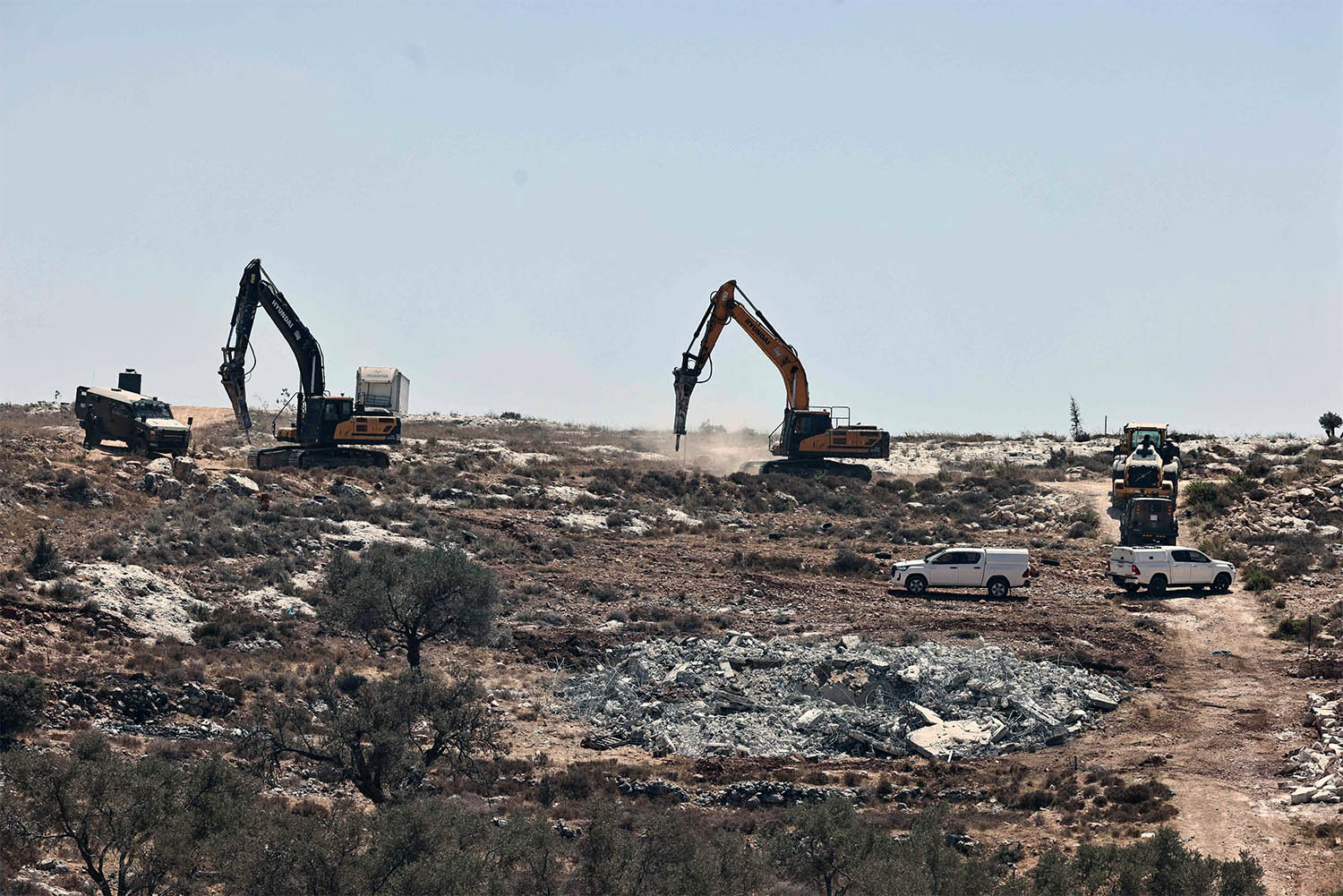Israeli bulldozers destroying houses in the occupied West Bank