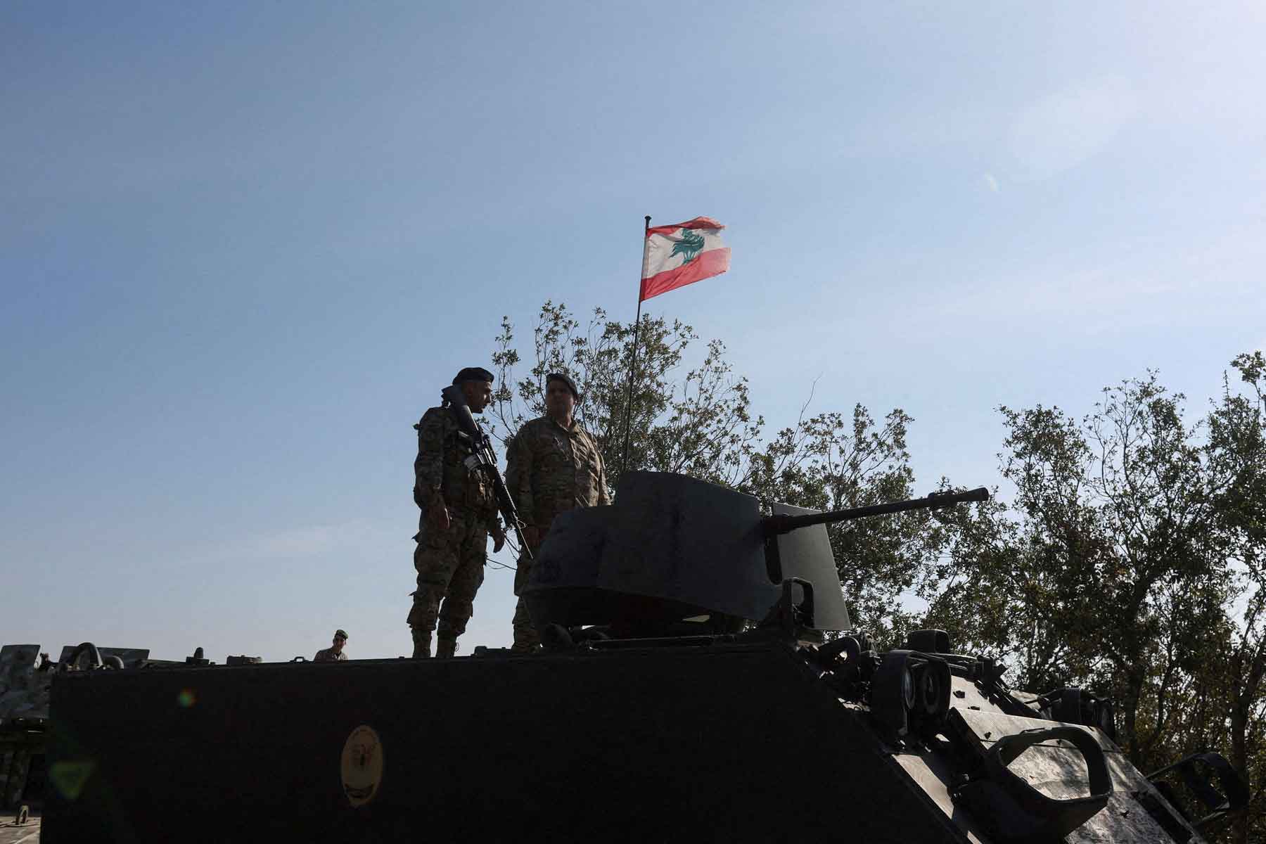 Lebanese army members stand on a military vehicle in the southern Litani sector, in Alma Al-Shaab, near the border with Israel, southern Lebanon, November 28, 2025. 