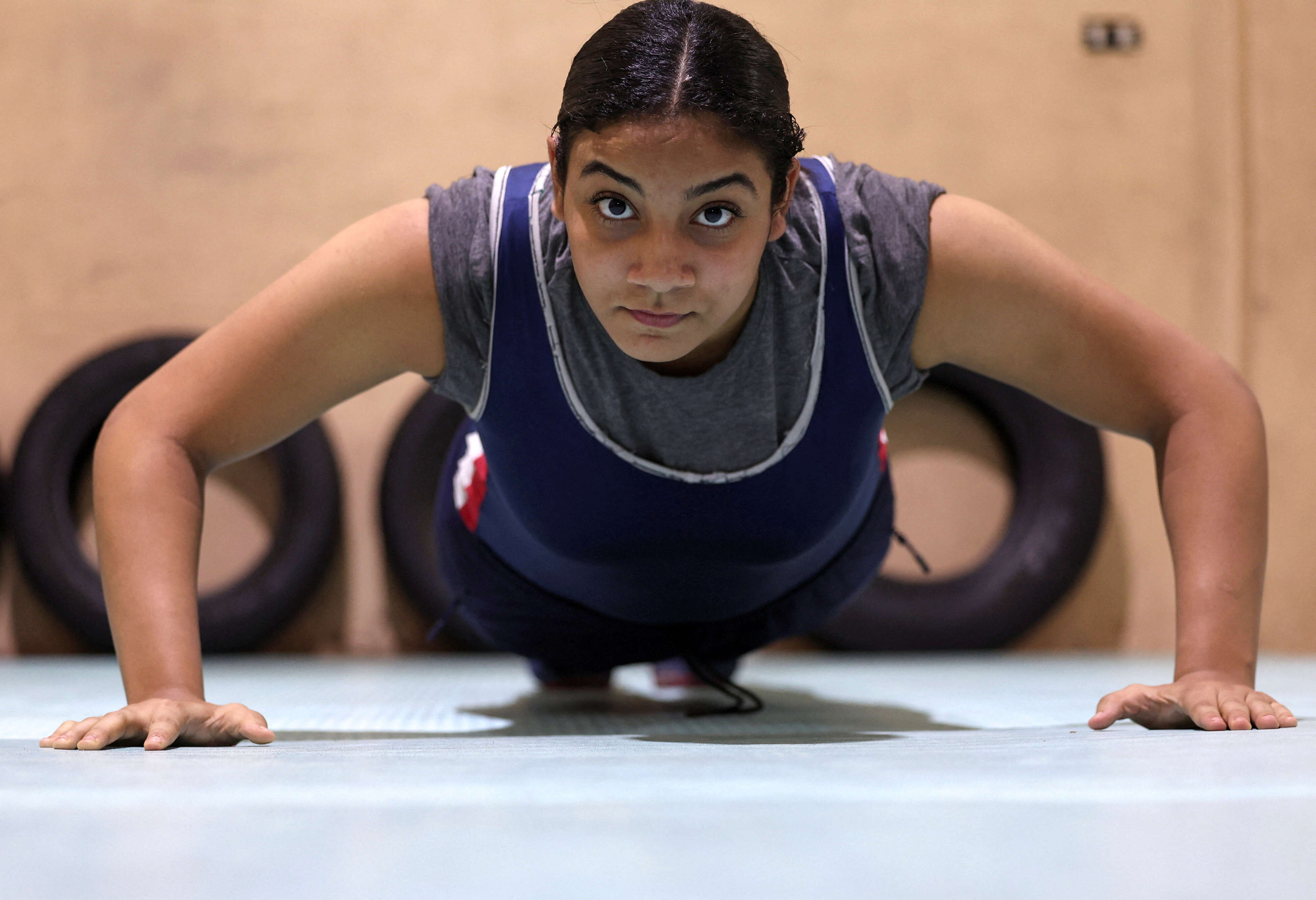 Wrestler Rodaina Gamal, 15, in action during a training session at the one-room Manshiya club in El Mansoura, Egypt, December 15, 2025. 