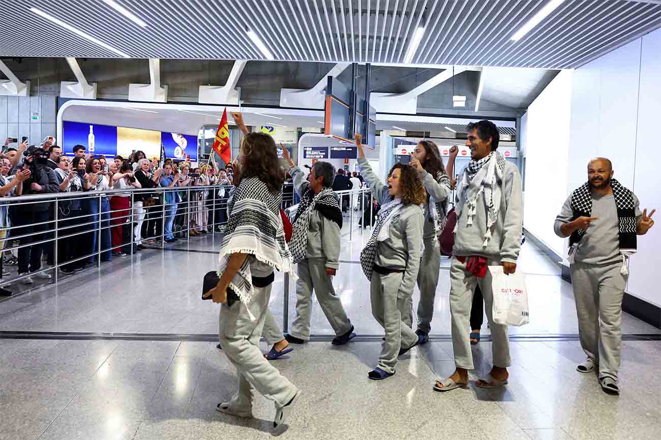 French activists from the Gaza-bound Global Sumud Flotilla gesture upon arrival at Charles de Gaulle Airport near Paris on May 22