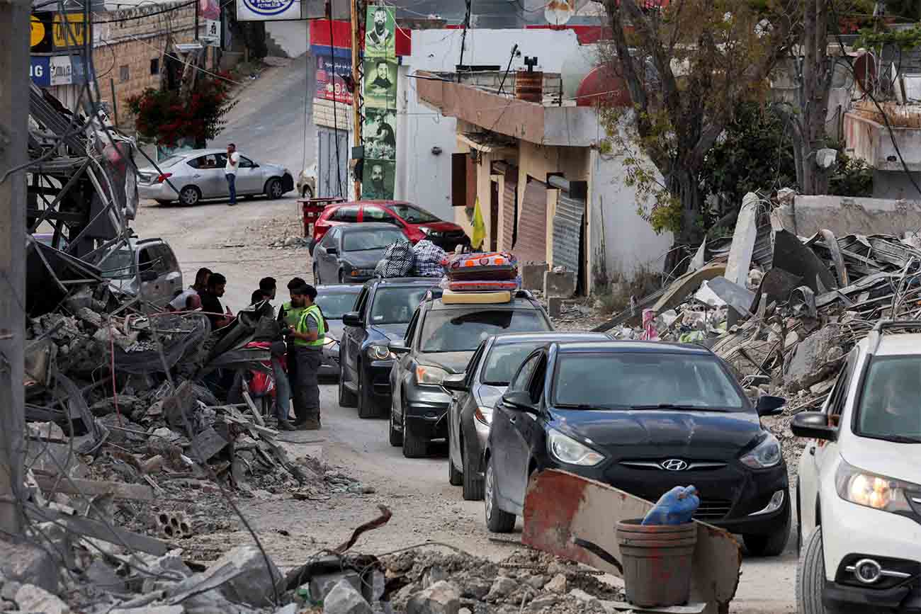 Displaced people transport their belongings in cars, as they make their way back to their homes in southern Lebanon