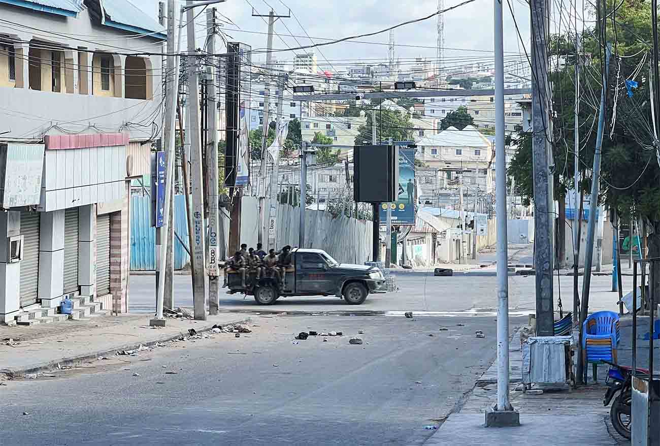 A truck carrying Somali security forces drives across a street ahead of a protest against Somalia's President
