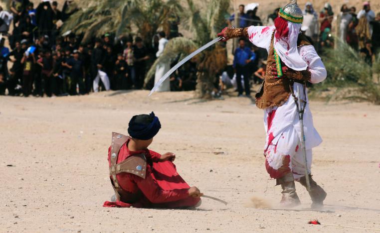 Local actors dressed as ancient warriors re-enact a scene from the 7th century battle of Karbala in Najaf, Iraq.