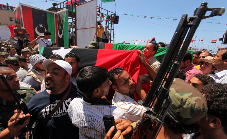 People attend the burial of Libyan rebel military commander Abdel Fattah Younes in Benghazi July 29, 2011.