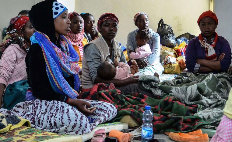 People who fled the violence in the Ethiopian capital Addis Ababa sit at a temporary shelter.