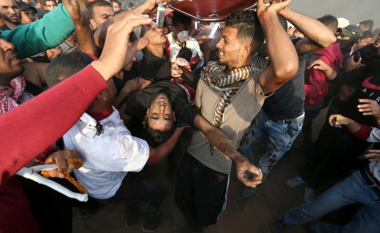 A wounded Palestinian is evacuated during a protest calling for lifting the Israeli blockade on Gaza.