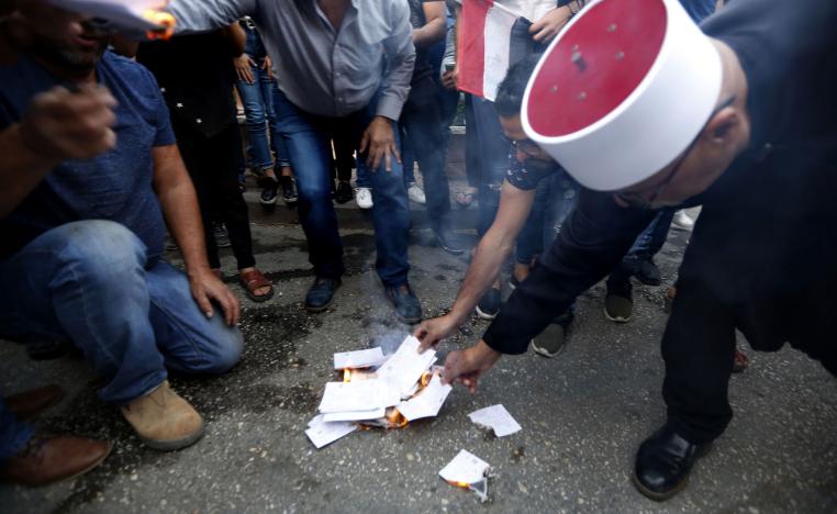 Druze residents of Majdal Shams in the Israeli-annexed Golan Heights set ablaze makeshift ballot papers during a protest on October 19, 2018.