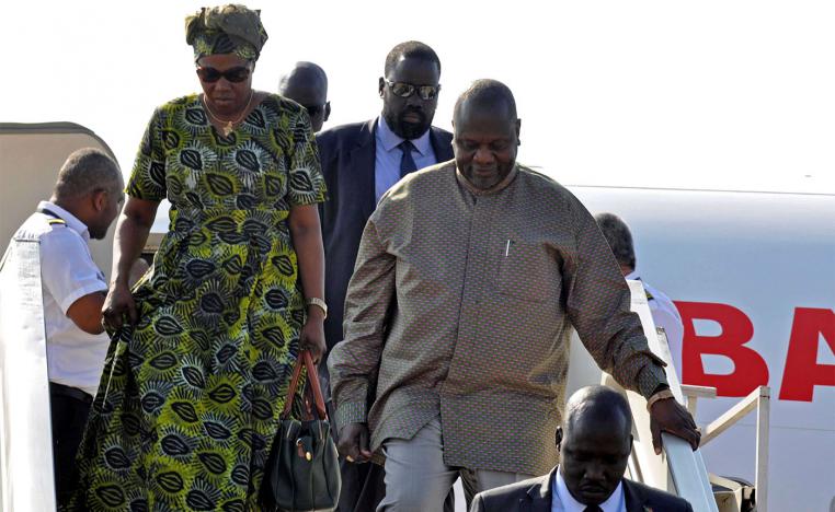South Sudan rebel leader Riek Machar and his wife Angelina Teny disembark from the plane after arriving at Juba airport in South Sudan
