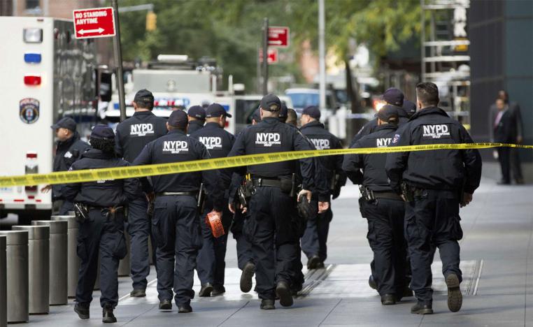 Officers inspect the scene outside the Time Warner Center 