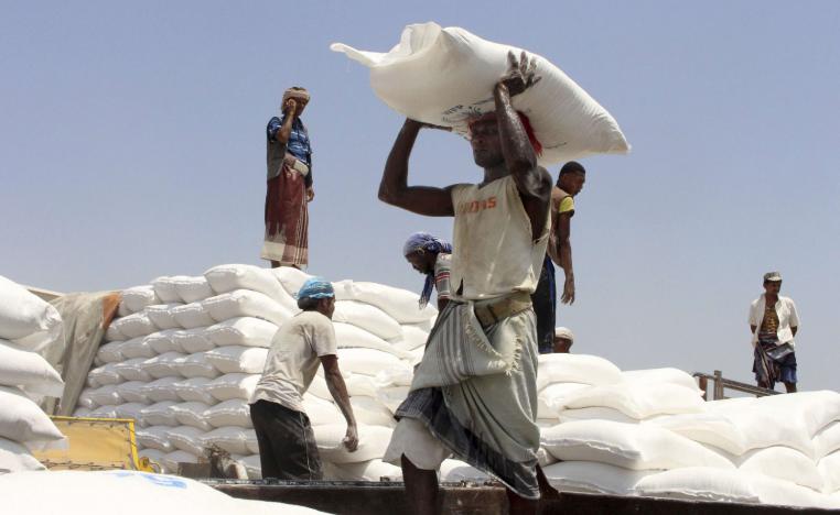 Men deliver UN World Food Programme (WFP) aid in Hajjah, Yemen.