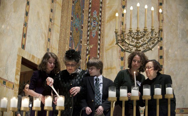 Holocaust survivors light symbolic candles at the Temple Emanu-El during the annual Holocaust Remembrance Day in New York