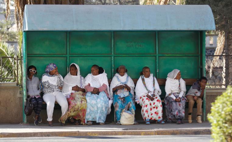 Passengers wait for the bus at a stop along a street in Asmara, Eritrea.