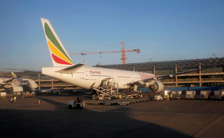 Workers service an Ethiopian Airlines plane at the Bole International Airport in Ethiopia's capital Addis Ababa