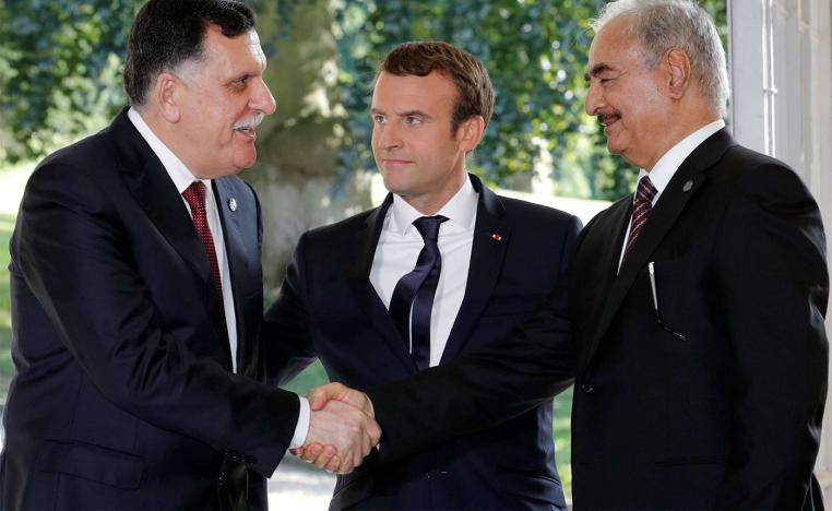 French President Emmanuel Macron stands between Libyan Prime Minister Fayez al-Sarraj (L), and General Khalifa Haftar (R), commander in the Libyan National Army (LNA)