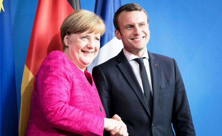 الرئيس الفرنسي امانويل ماكرون والمستشارة الالمانية أنجيلا ميركل