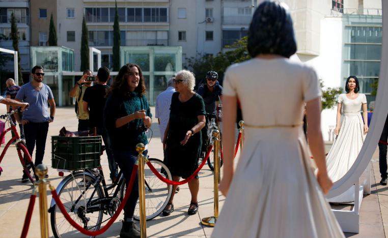 People look at an installation, including a statue resembling Israeli Minister of Sports and Culture, Miri Regev, in Tel Aviv, Israel on November 8, 2018.
