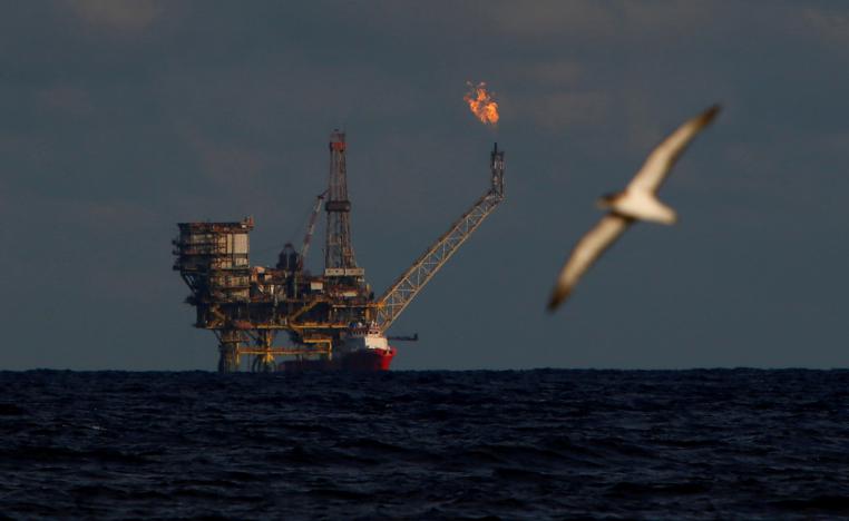A seagull flies in front of an oil platform in the Bouri Oilfield some 70 nautical miles north of the coast of Libya, October 5, 2017.