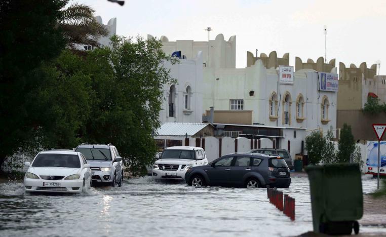Roads flooded and workers were seen mopping up inside office buildings
