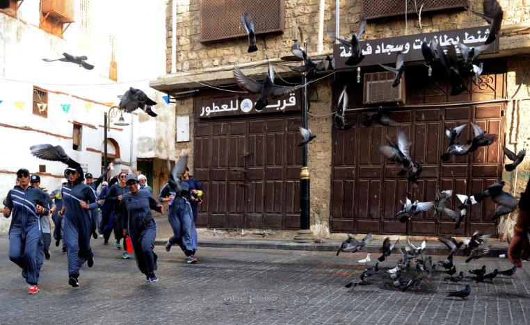  Saudi women jog in the streets of Jeddah's historic al-Balad district on March 8, 2018.