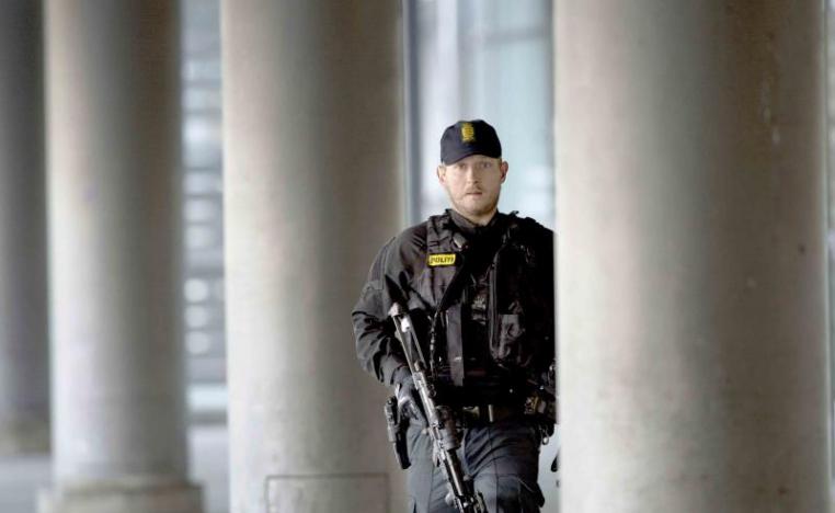 A Danish policeman stands guard outside a building in Copenhagen