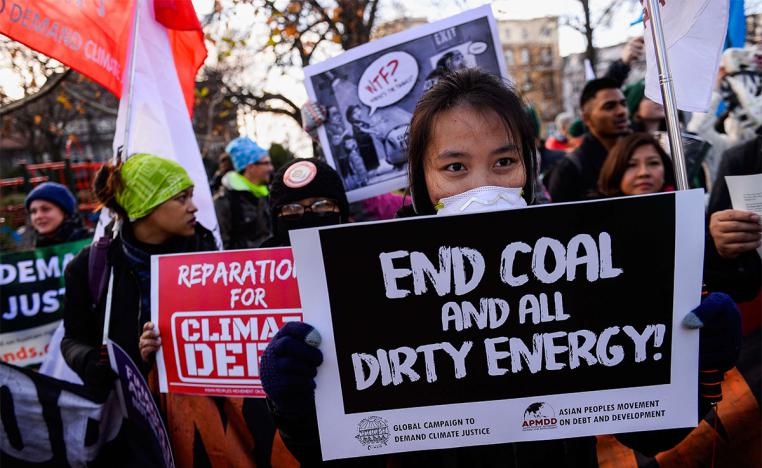 People march with placards during a demonstration against climate change in Katowice
