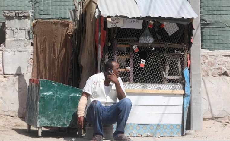 A civilian, injured following an explosion near the president's residence, uses his mobile phone as he waits for medical attention in Mogadishu, Somalia December 22, 2018.