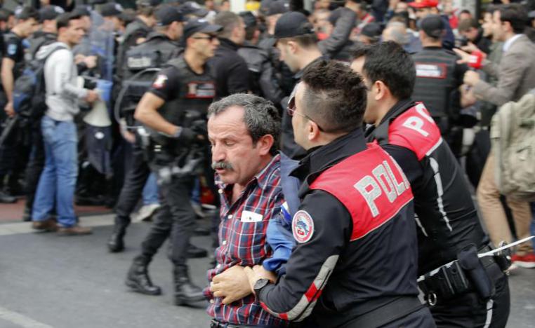 Police officers detain a Turkish man during protests in Istanbul, last May