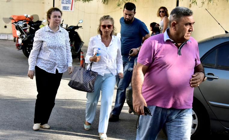 Turkish journalist Nazli Ilicak (C), also a well-known commentator and former parliamentarian, is escorted by a police officer (R) and her relatives (L and rear) after being detained and brought to a hospital for a medical check in Bodrum, Turkey, July 26, 2016.