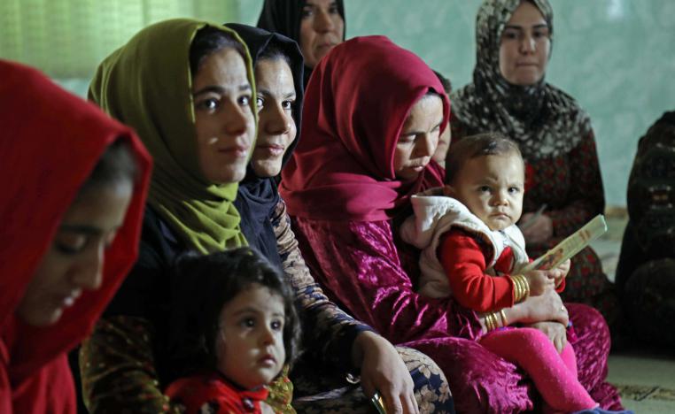 Women and young girls listen to Rasul (not pictured) an Iraqi Kurdish activist with the non-profit organisation WADI, as she peaks about the harms of genital mutilation in Sharboty Saghira, a small village east of regional capital Arbil, on December 3, 2018.